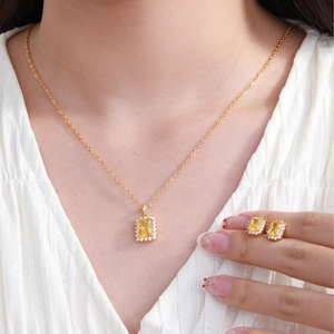 Elegant gold-plated geometric jewelry set featuring yellow gemstones and white zircons
