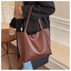 Retro deep brown large leather tote bag worn on shoulder showing its spacious capacity