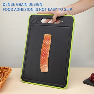 Detail of black non-slip cutting board with built-in grinder and green edge design