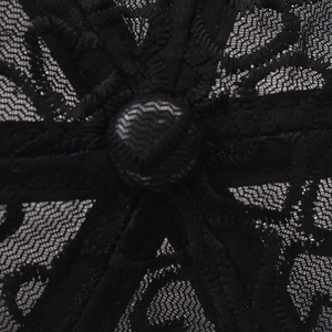 Macro detail of the breathable black lace floral pattern and mesh on this baseball cap