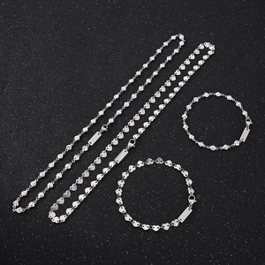 Detailed set of silver stainless steel heart chain necklaces and bracelets on black background