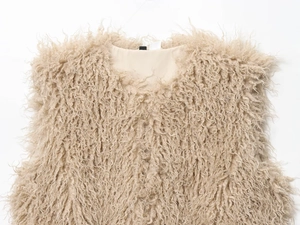 Detailed macro view of the fluffy faux fur texture on this camel shaggy vest for women