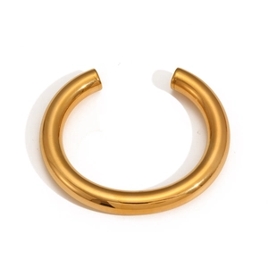 Close-up of a polished 18k gold-plated stainless steel C-shaped chunky bangle on white