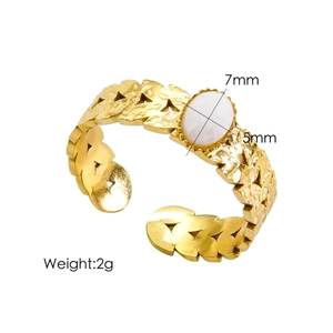 Detailed view of adjustable gold-plated ring featuring hollow leaf texture and white oval gem