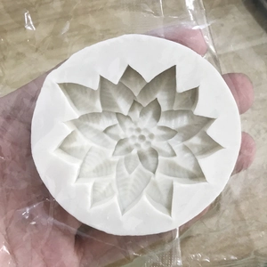 White silicone mold for holly berries and poinsettia flowers for soap and candle making