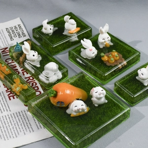 Miniature resin rabbit figurines on green grass base for DIY landscape craft projects