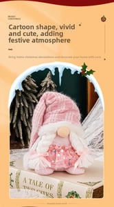 Detailed view of pink knitted Christmas gnome doll with sequins and braided hair