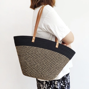 Chic two-tone woven tote bag with brown leather straps and large capacity for vacation