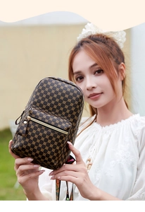 Detail of brown leather backpack with golden hardware and colorful patterned straps