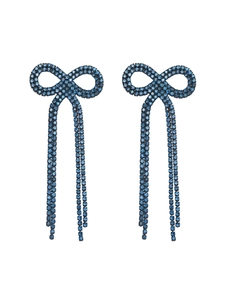 Detail of blue rhinestone bow earrings with long sparkling tassel chains on white background