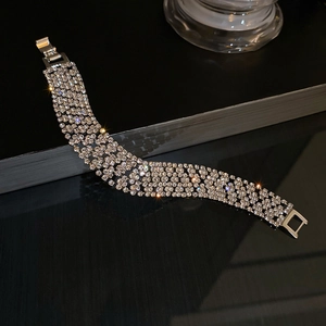 Macro shot of silver wide multi-row rhinestone bracelet with sparkling crystal details