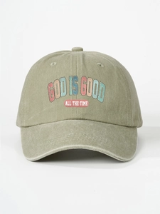 Detail of God Is Good printed text on vintage washed olive green baseball cap surface