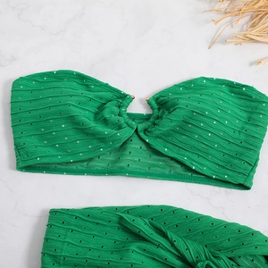 Macro detail of ribbed bright green bandeau bikini top with golden ring buckle