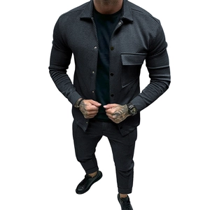 Detail of men's twill texture jacket and matching pants in dark grey ribbed fabric