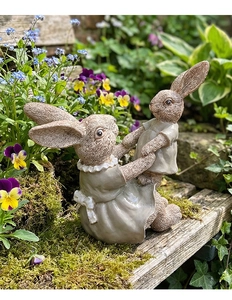 Detailed view of the realistic fur texture on resin garden bunny figurines outdoors