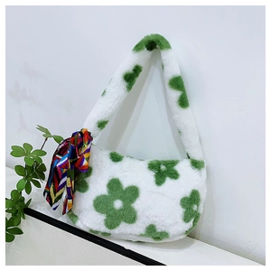Close-up of plush faux fur handbag with green floral patterns and silk scarf detail