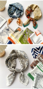 Detail of silk-feel square scarf with geometric prints and flower patterns on white background