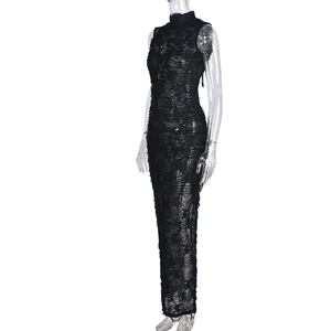 Detailed macro view of the distressed black lace fabric texture on a high-neck dress