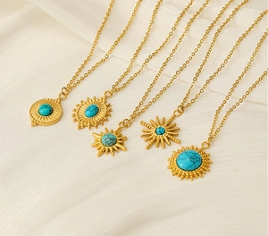 Detail view of five vintage 18K gold stainless steel necklaces with turquoise pendants