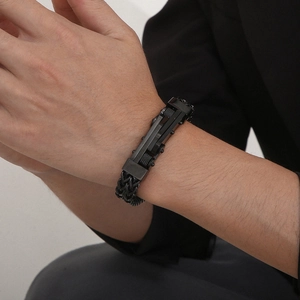 Close-up of a men's black stainless steel keel chain bracelet worn on a wrist