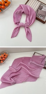 Detailed view of pink pleated square scarf showing the accordion texture and styling effect