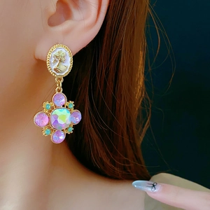 Baroque cameo drop earring with pink crystal cross and vintage floral detail on model