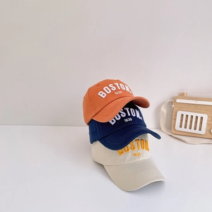 Three cotton baseball caps in orange, navy, and beige with Boston embroidery detail