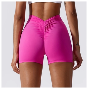 Detail view of the rose pink scrunch butt yoga shorts showing the V-waist and stretch fabric