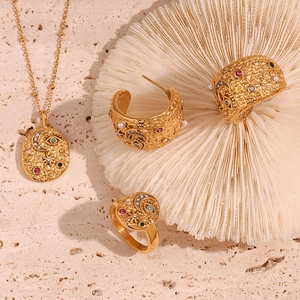 Detail view of 18K gold plated jewelry set with star, moon and colorful gemstones