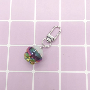 Miniature cat paw keychain with iridescent rainbow surface and silver lobster clasp