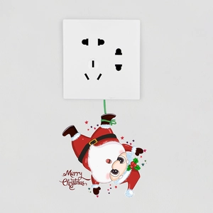 Detail of Santa Claus wall sticker with Merry Christmas text near white power switch