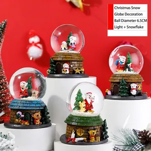 Close-up of 6.5cm Santa Claus crystal ball with LED lights and automatic snow feature