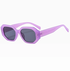 Detail of purple hexagonal sunglasses with silver studs and gray UV lenses
