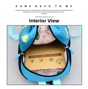 Internal view of blue cartoon dinosaur backpack showing spacious main compartment with lining