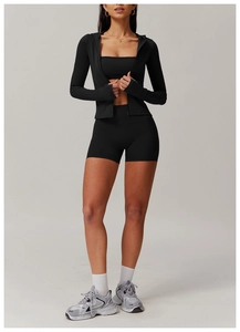 Three-piece black yoga set with zip hoodie, sports bra and high-waisted shorts