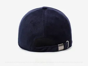 Detail view of corduroy baseball cap back with adjustable metal buckle in navy blue