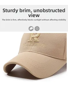 Detailed close-up of a stiff brim and embroidery on a beige cotton baseball cap