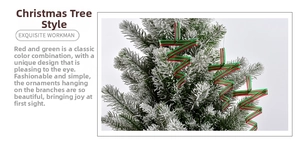 Close-up of red and green striped ribbon swirl ornament hanging on a snowy Christmas tree