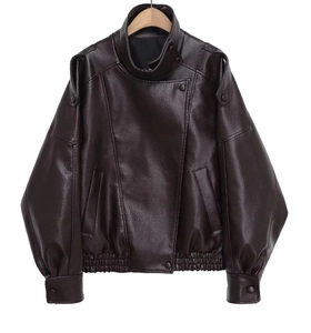 Detail of dark brown faux leather motorcycle jacket with realistic litchi grain texture