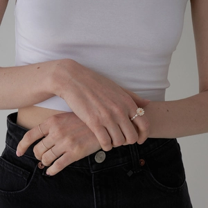 Minimalist daisy pearl elastic ring for women shown on hand with stacked styling