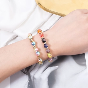 Golden flat round CCB spacer beads on colorful beaded bracelets with textured metal finish