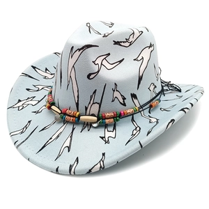 Detail of western cowboy hat with flying bird pattern and colorful beaded hatband