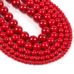 Macro view of bright red round natural stone beads in various sizes for jewelry making