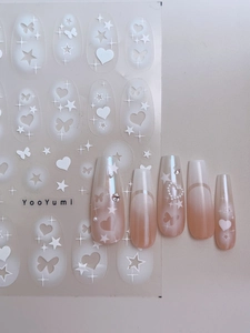 Detail of long ballerina nails with butterfly patterns and self-adhesive nail stickers