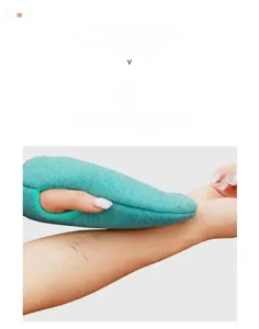 Detailed view of green exfoliating bath glove with coarse sandy texture and thumb hole design