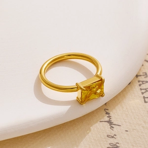 Detailed macro shot of an 18K gold-plated titanium ring with a square yellow gemstone