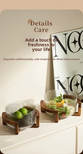 Detailed view of glass salad bowls with vertical stripes and wooden cross stands