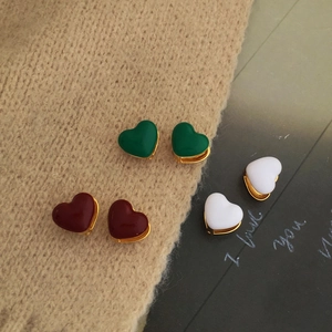 Detailed close-up of heart enamel hoop earrings in green, burgundy, and white gold-plated