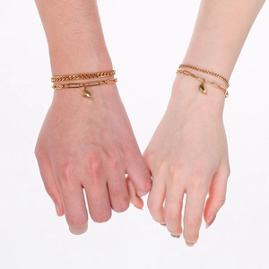 Golden double-layer stainless steel heart magnetic couple bracelets shown on models