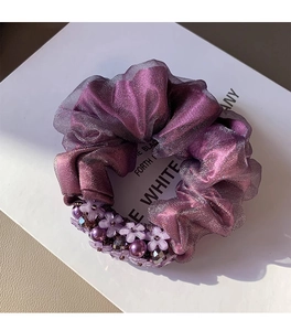 Detail of purple organza scrunchie with 3D flower decorations and pearlescent beads